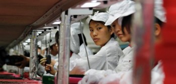 Workers are seen inside a Foxconn factory in the township of Longhua in the southern Guangdong province