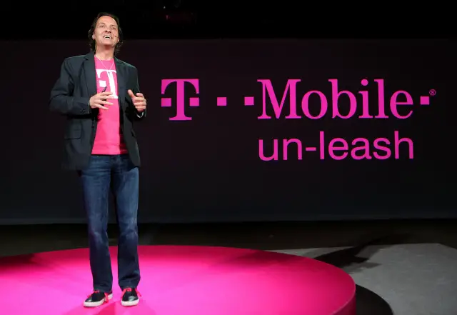 In this photo released by T-Mobile, T-Mobile CEO John Legere says T-Mobile will ?un-leash? customers from the cost and complexity of wireless with Simple Choice, a plan promising simple and affordable rates, no annual contracts and the ability to upgrade devices whenever you want, at a press conference in New York, March 26, 2013. T-Mobile also said iPhone 5 will be in its stores and online April 12. INSIDER IMAGES/Gary He for T-Mobile  (UNITED STATES)