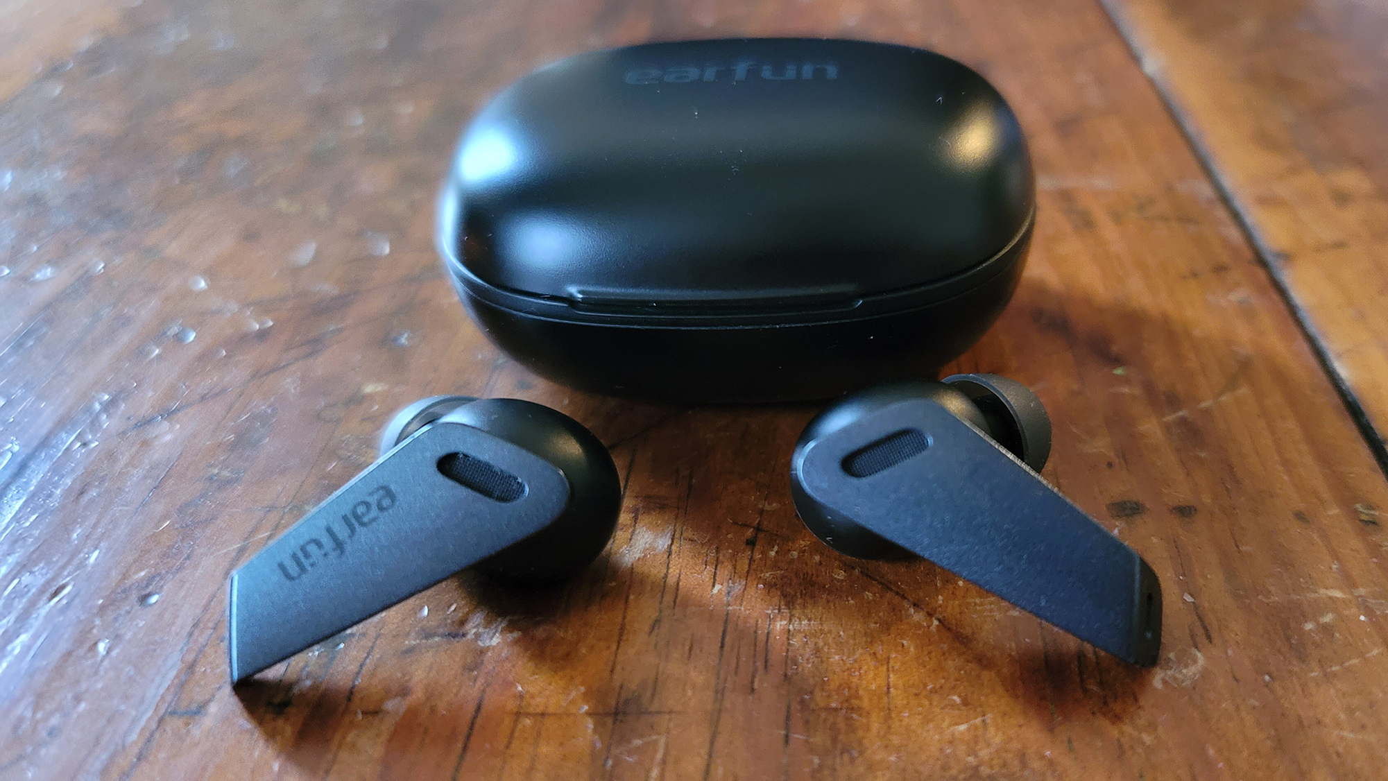 EarFun Air Pro true wireless earbuds sitting in front of their case